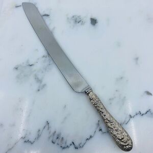 Antique sterling silver repousse handled 12" cake knife.